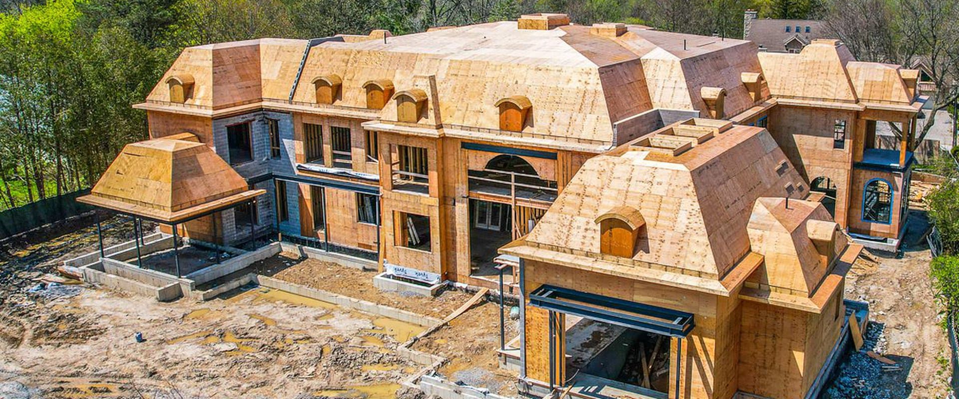 Konstruction Group construction site with steel beams and wood framing