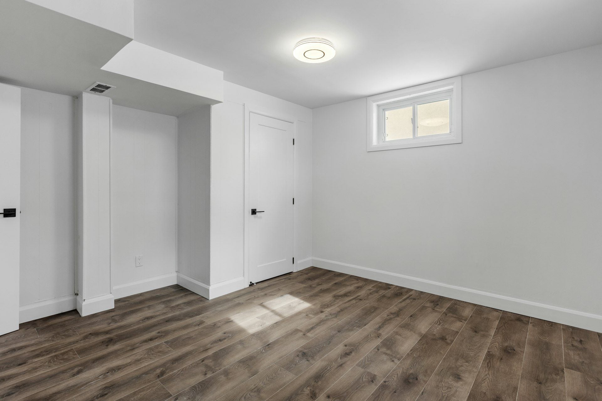 Empty room with finished drywall and wooden floors