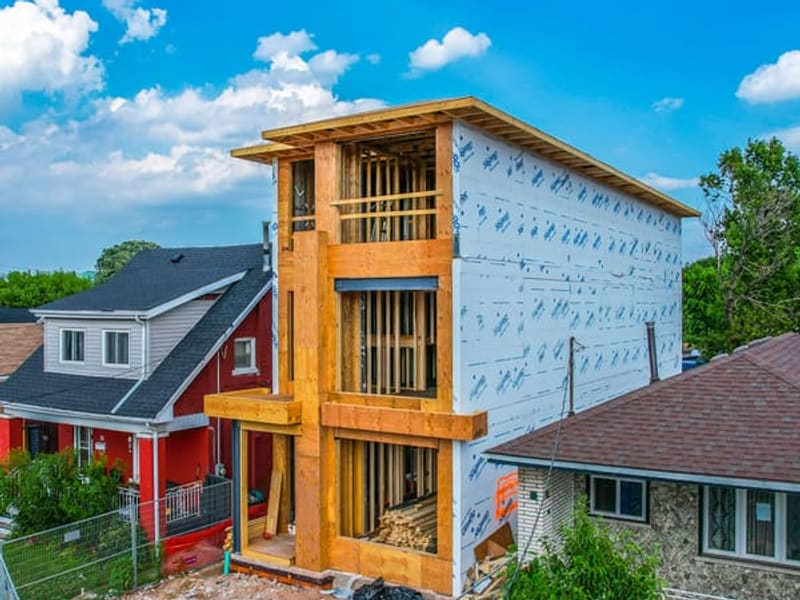 Rear view of multiplex showing wood framing with housewrap partially installed