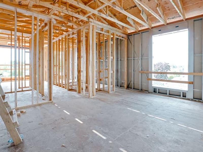Interior open concept layout with wood and metal stud framing for multiplex unit