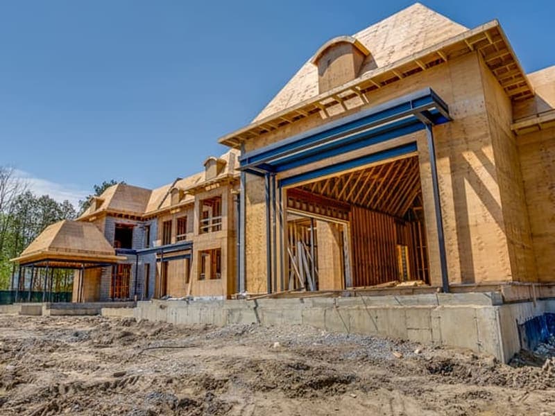 Front elevation of custom home showing steel moment frames and garage bay framing