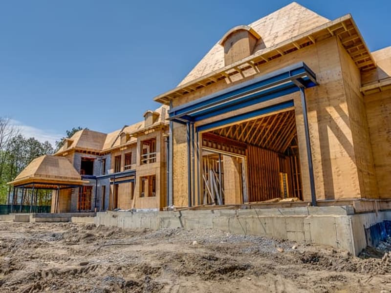 Front elevation of custom home showing steel moment frames and garage bay framing