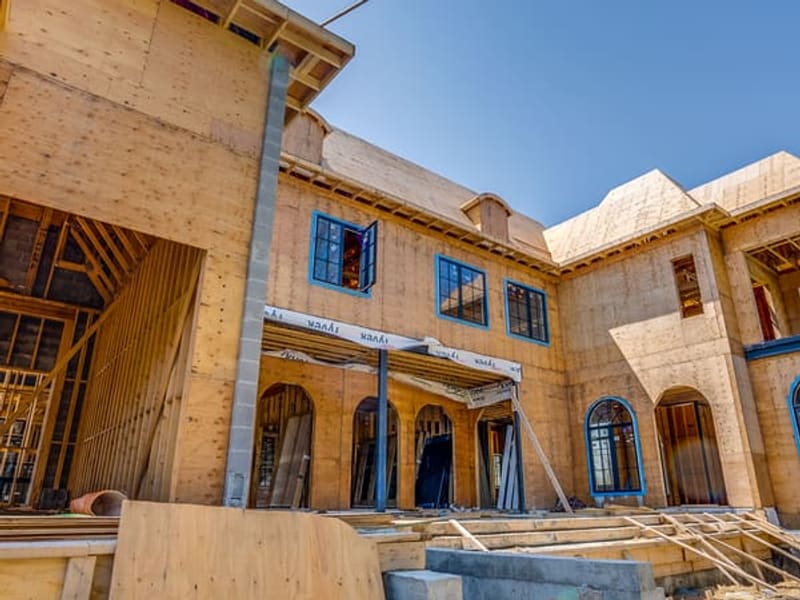 Interior courtyard view of custom home with arched windows and steel column supports
