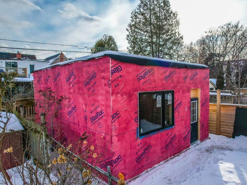 Detached garden suite wrapped in GlasRoc sheathing with window and door installed