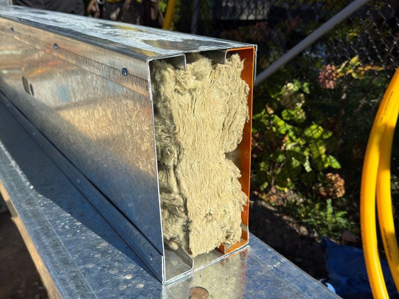 Close-up of metal box beam filled with mineral wool insulation for fire separation