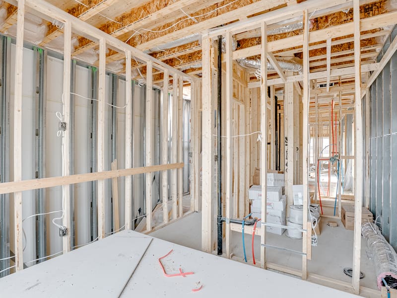 Interior metal stud framing with electrical rough-in and plumbing for multiplex unit