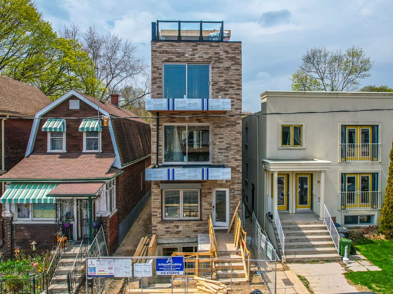 Four-storey multiplex with brick and metal cladding nearing completion in Leslieville, Toronto