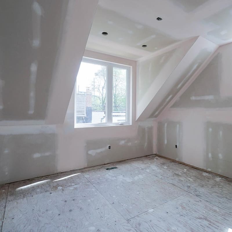 Drywall taping first coat with paper tape at joints