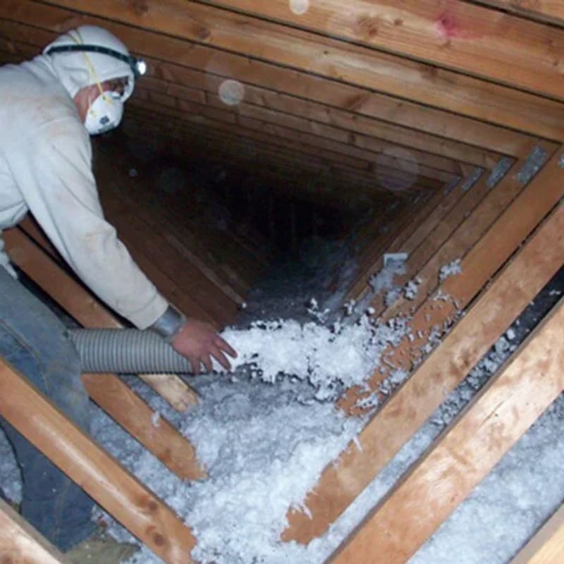 Blown-in fiberglass insulation in attic