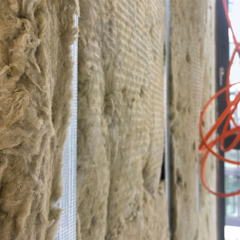 Acoustic insulation in party wall between units